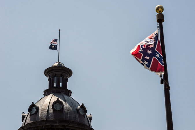The Confederate flag flies at the South Carolina statehouse in the wake of mass murder by a racist. (photo by Sean Rayford for Getty Images, via the New York Times)