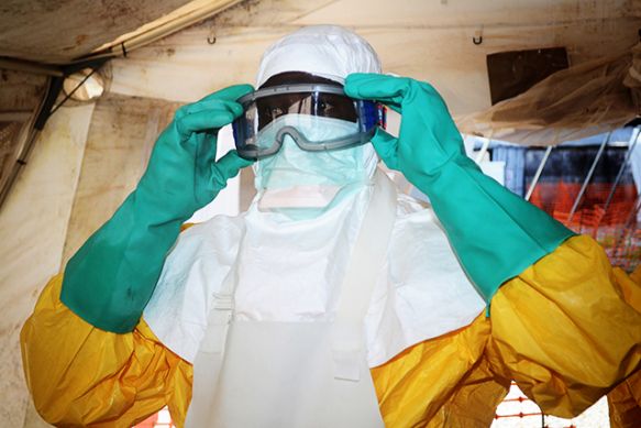 A member of Doctors Without Borders dons protective gear at the isolation ward of the Donka Hospital in Conakry, Guinea, where people infected with the Ebola virus are being treated. (Photo: Cello Binani/AFP/Getty Images)